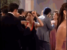 a group of people are dancing on a dance floor at a party .