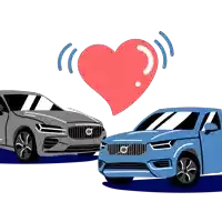 two volvo cars are standing next to each other with a red heart above them