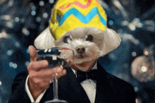 a man in a tuxedo holds a wine glass with a dog 's head on it