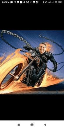 a man is riding a motorcycle with flames coming out of the front wheel .