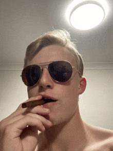 a man wearing sunglasses smoking a cigar