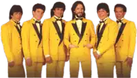 a group of men in yellow suits and bow ties pose for a picture