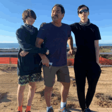 a man and two boys are posing for a picture together