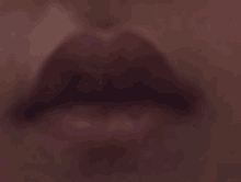 a close up of a person 's mouth with a blurred background