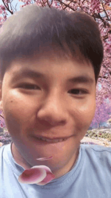 a close up of a man 's face with a flower in the background