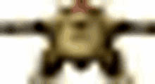 a blurred image of a toy robot with a red crown on its head and arms .