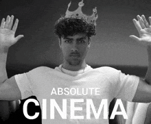 a black and white photo of a man wearing a crown and the words absolute cinema below him