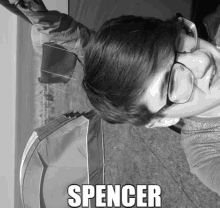 a black and white photo of a person with the name spencer on the bottom