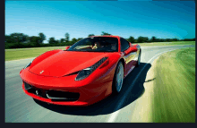 a red ferrari is driving down a road