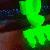 a green glow in the dark figurine of a cat