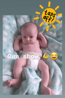 a baby in a diaper is laying on a blanket with a sticker that says taps aff gun show