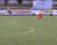 a group of soccer players are playing on a field with a building in the background that says ' snickers '