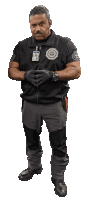 a man wearing a black vest with a badge that says ' scp ' on it