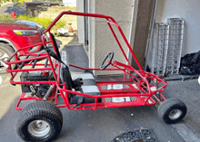 a red buggy with the letters bt on it