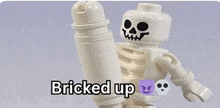 a lego skeleton is holding a bottle and the words bricked up are on the bottom