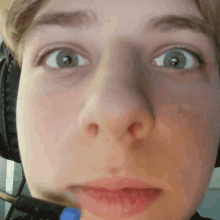 a close up of a person 's face with headphones