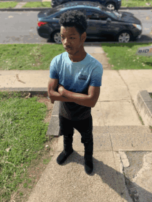 a young man wearing a blue shirt that says ' united states army ' on it