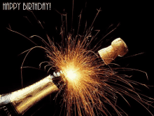 a bottle of champagne with sparks coming out of it and the words happy birthday on the bottom