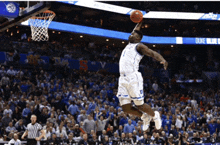 a duke blue devils basketball player is jumping in the air to dunk the ball