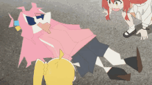 a girl in a pink shirt is laying on the ground while another girl stands nearby