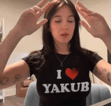 a woman wearing a black t-shirt that says i love yakub