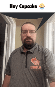 a man wearing glasses and a shirt that says extralife on it