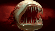 a close up of a monster 's mouth with blood coming out of it