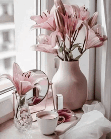 a vase of flowers sits on a window sill next to a cup of coffee