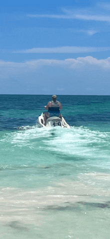 a man is riding a jet ski with the number 454 on it