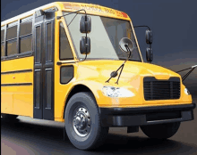 a yellow school bus with the word school on the front