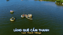 an aerial view of boats on a lake with the words lang que cam thanh cam thanh village on the bottom