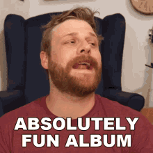 a man with a beard is sitting in a chair with the words " absolutely fun album " above him