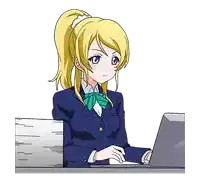 a girl is sitting at a desk using a laptop