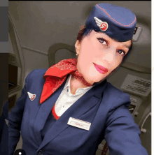 a stewardess is wearing a name tag that says " air russia "