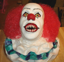 a cake with a clown face and red hair