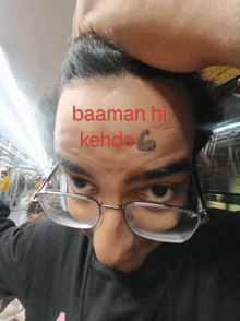 a man wearing glasses has a tattoo on his forehead that says baaman hi kehde