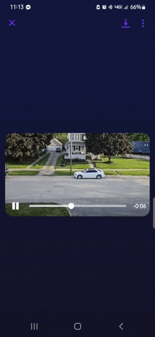 a phone screen shows a video of a car driving down the street