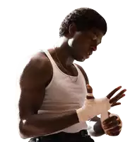 a man in a white tank top is wrapping his hands in white bandages