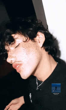 a close up of a young man 's face with a picture of a man on the bottom right