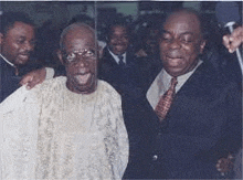 two men in suits and ties are posing for a picture .