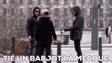 a group of people standing on a street with the words tie un barjot la meque written on the bottom .