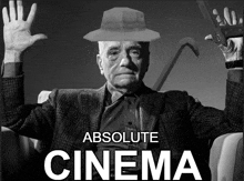 a black and white photo of an older man with the words absolute cinema below him