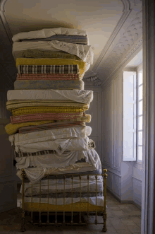 a stack of mattresses on top of each other in a room