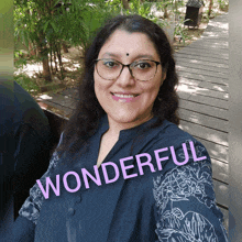 a woman wearing glasses and a blue shirt with the word wonderful written on it