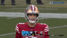 a football player stands on the field with the fox championship logo behind him