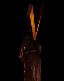 a statue of a man carrying a wooden cross on his back