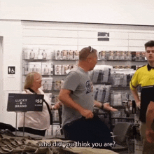 a man talking to a woman in a store with a sign that says lucky brand