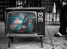 a black and white photo of an old television that says " people over the chinese communication "