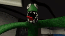 a green monster with a red tongue sticking out of its mouth is standing in a dark room .