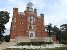 a large red brick building with a clock tower